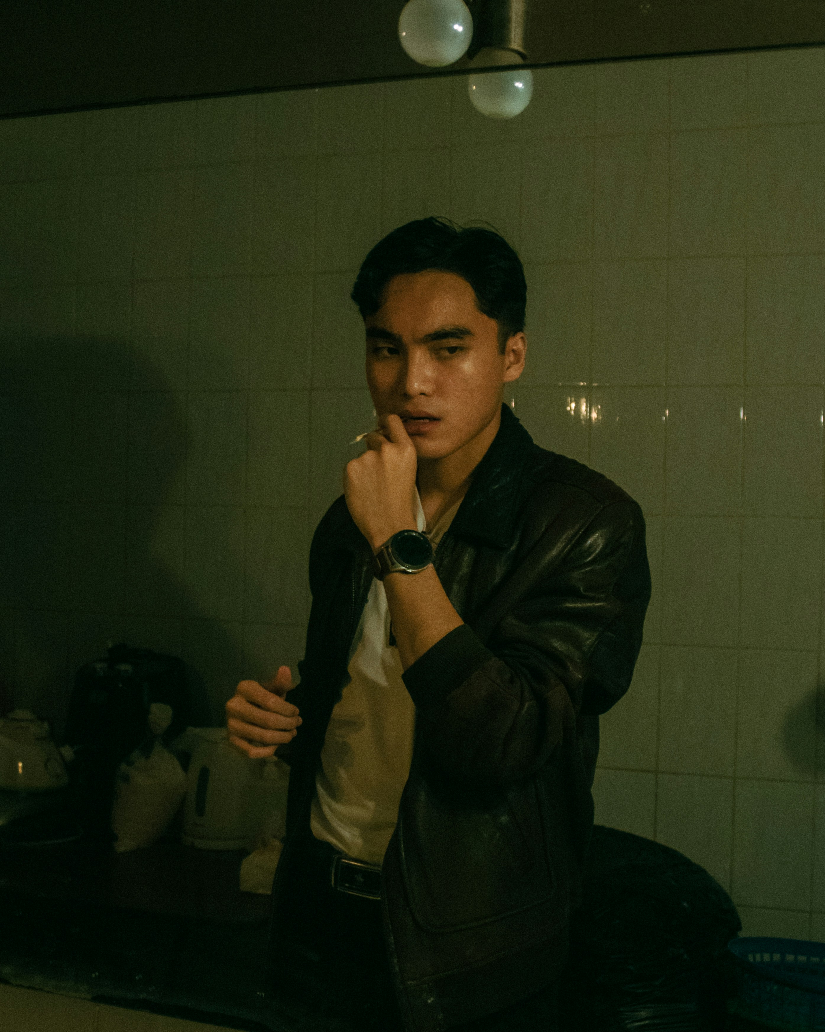 man in black jacket holding phone