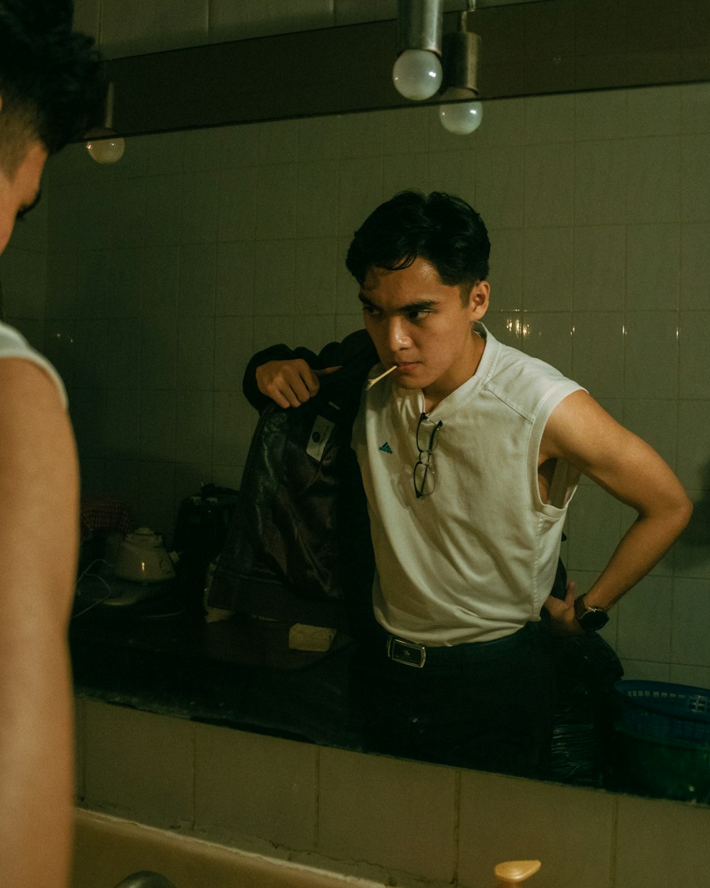 man in white polo shirt and black pants standing beside man in white polo shirt