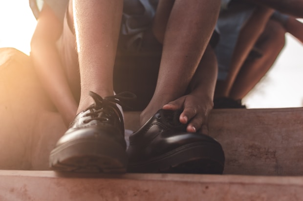 person wearing black nike shoes