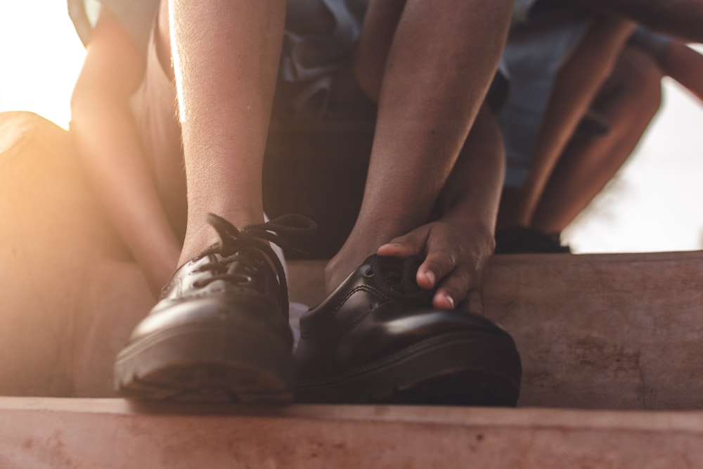 person wearing black nike shoes