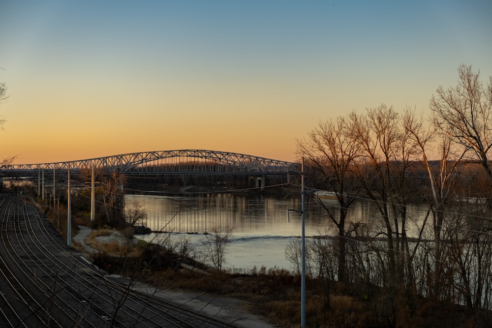 a bridge over a body of water at sunset