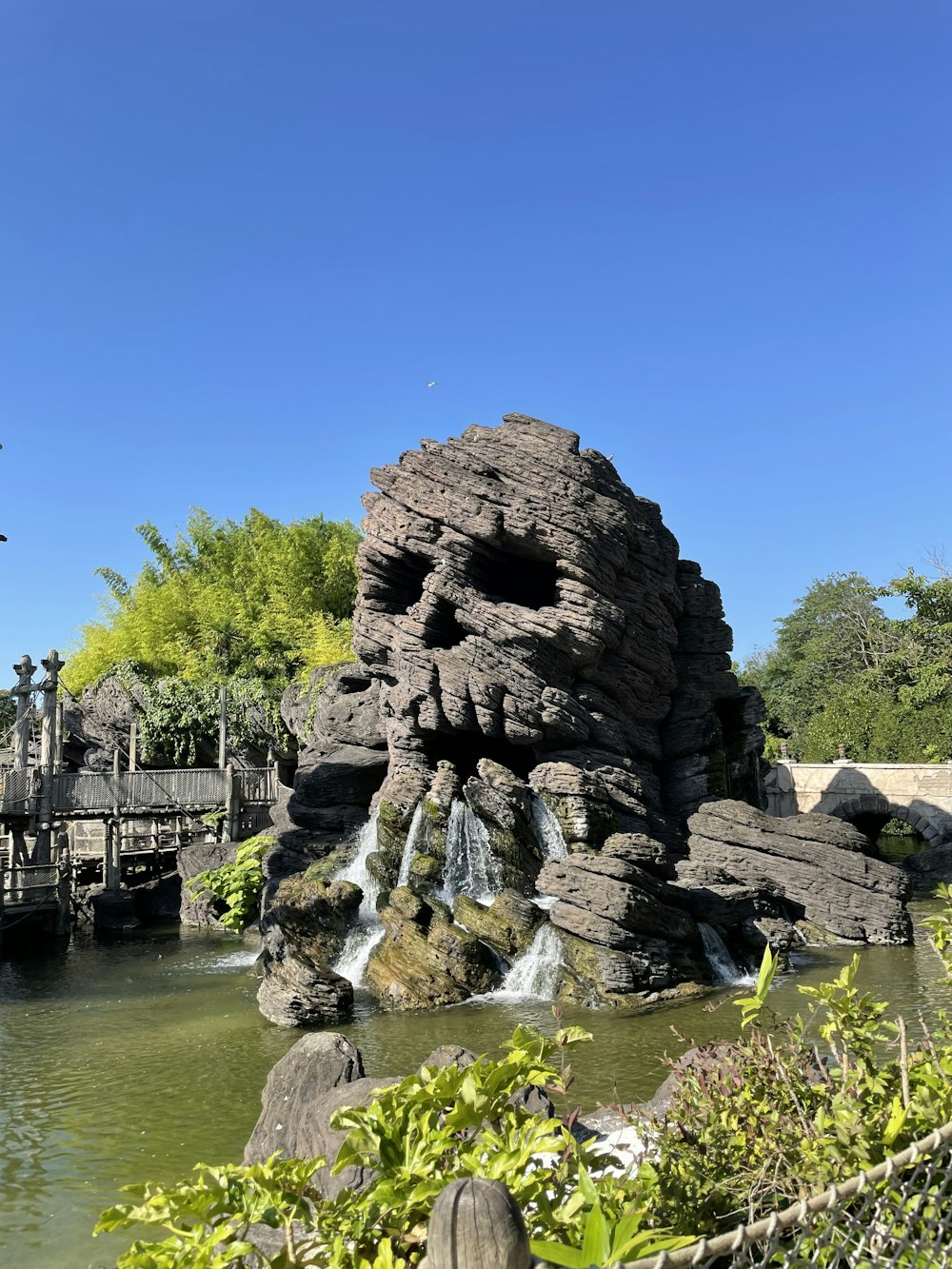 gray rock formation on body of water during daytime