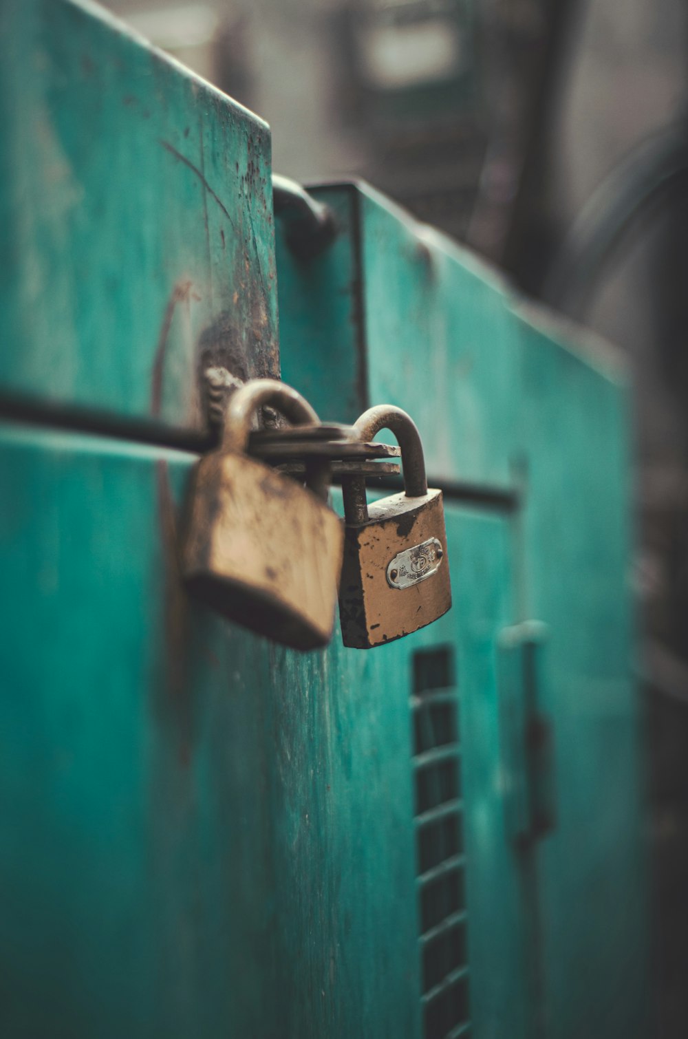 brass padlock on green wooden door