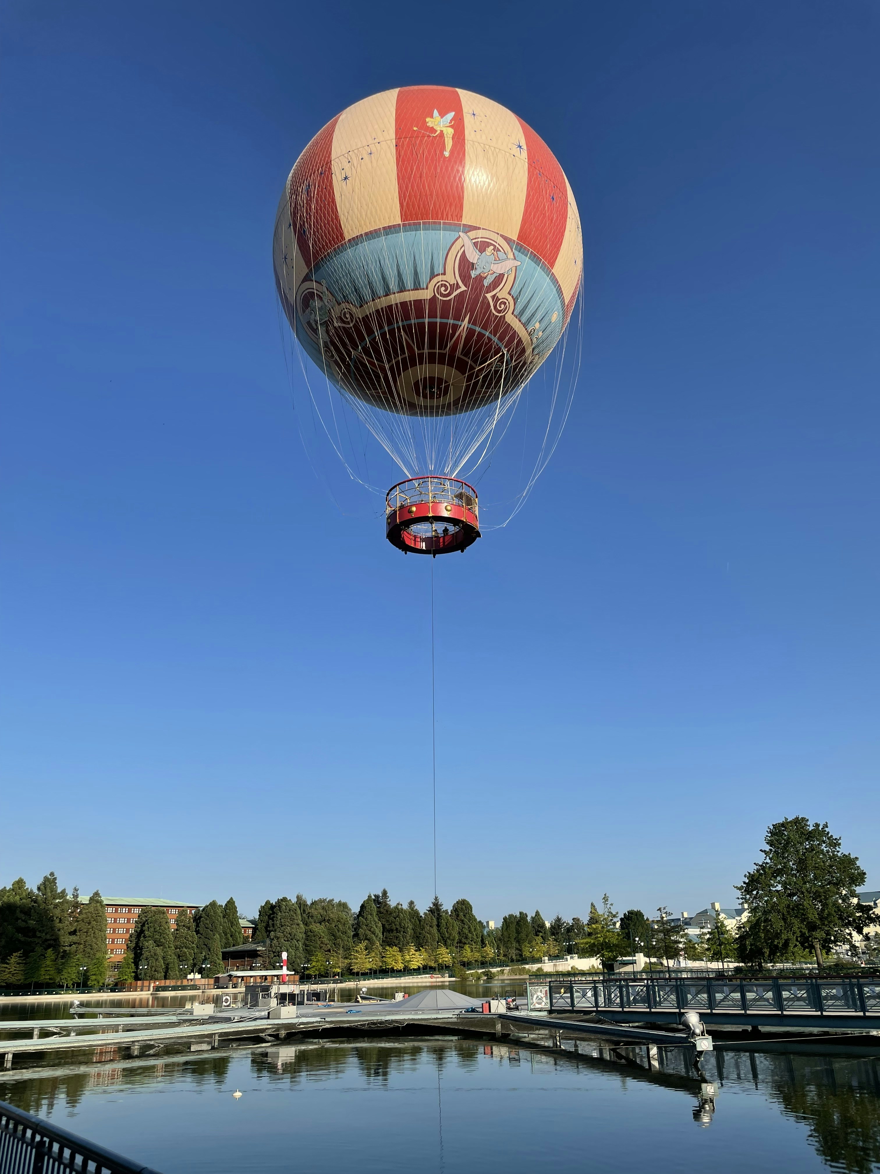 red and white hot air balloon in mid air during daytime