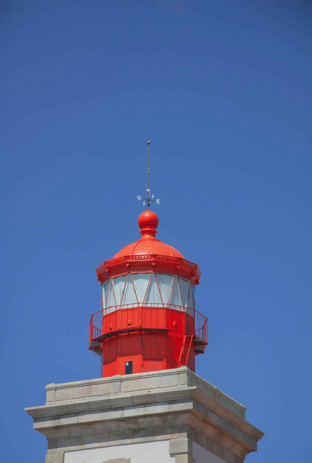 red and white concrete tower under blue sky during daytime