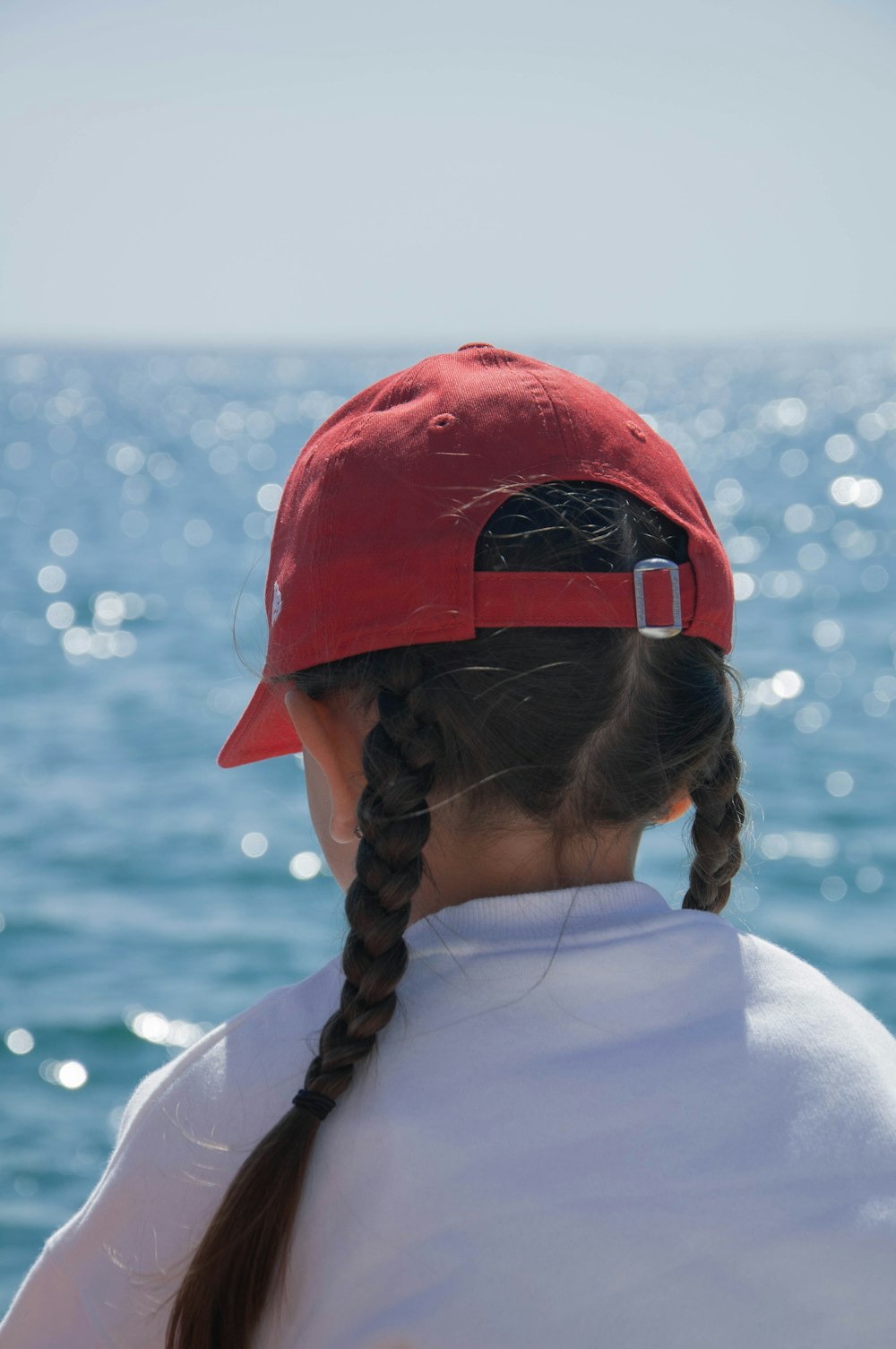 woman in white shirt wearing red and black helmet