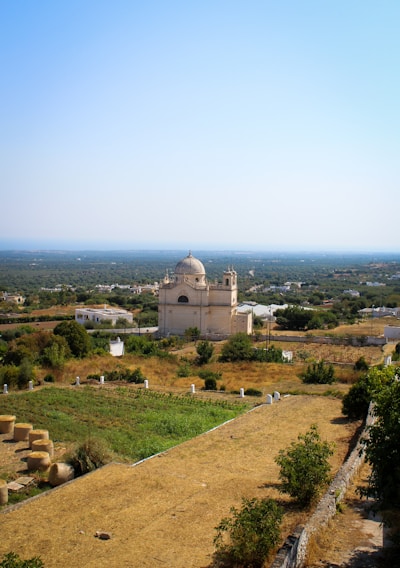 A serene landscape depicting a church and a government building side by side.