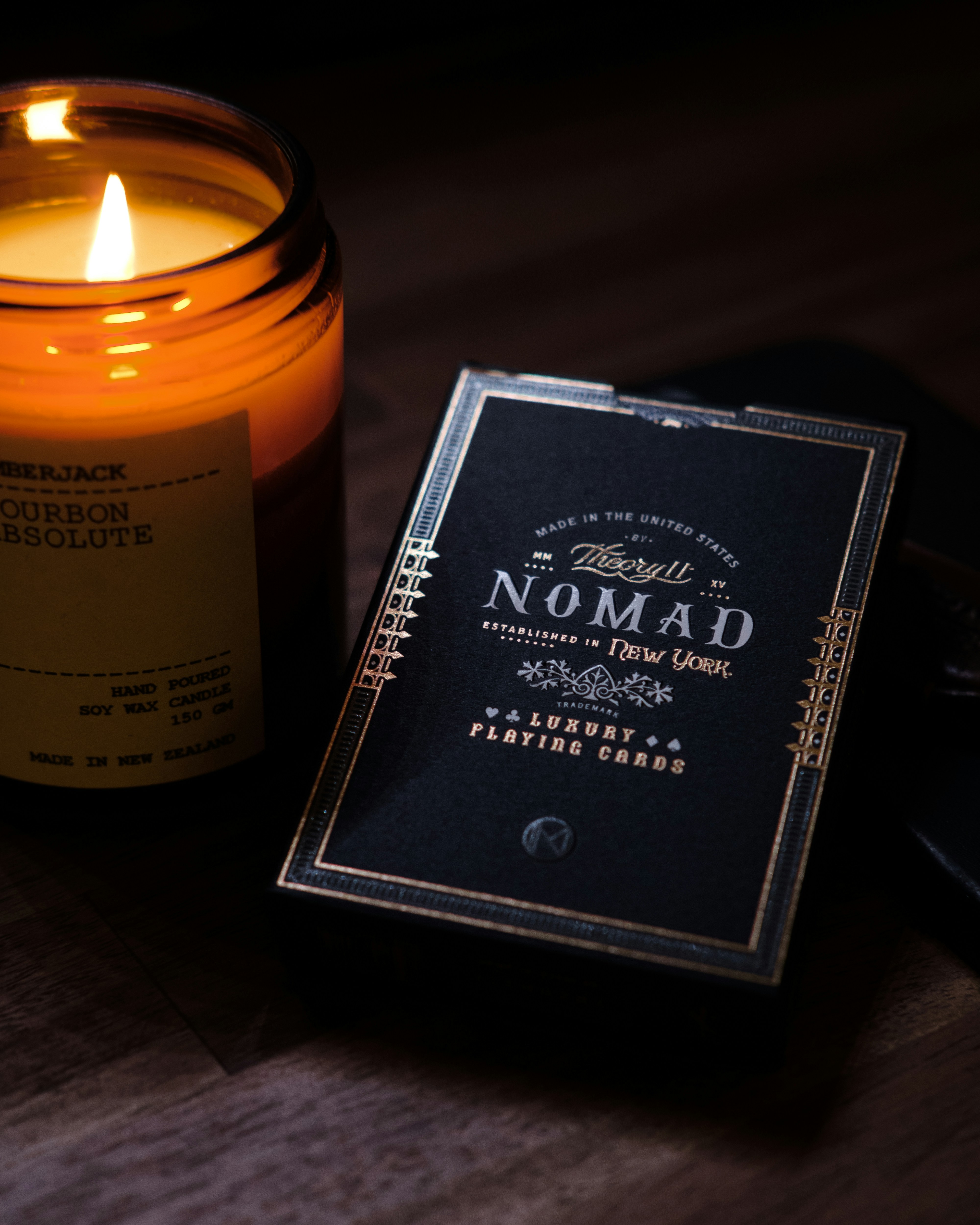 A candle sitting next to a book on a table