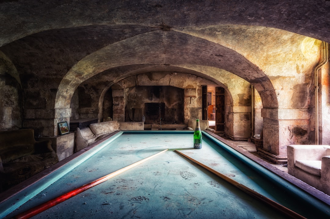 gray concrete tunnel with green light