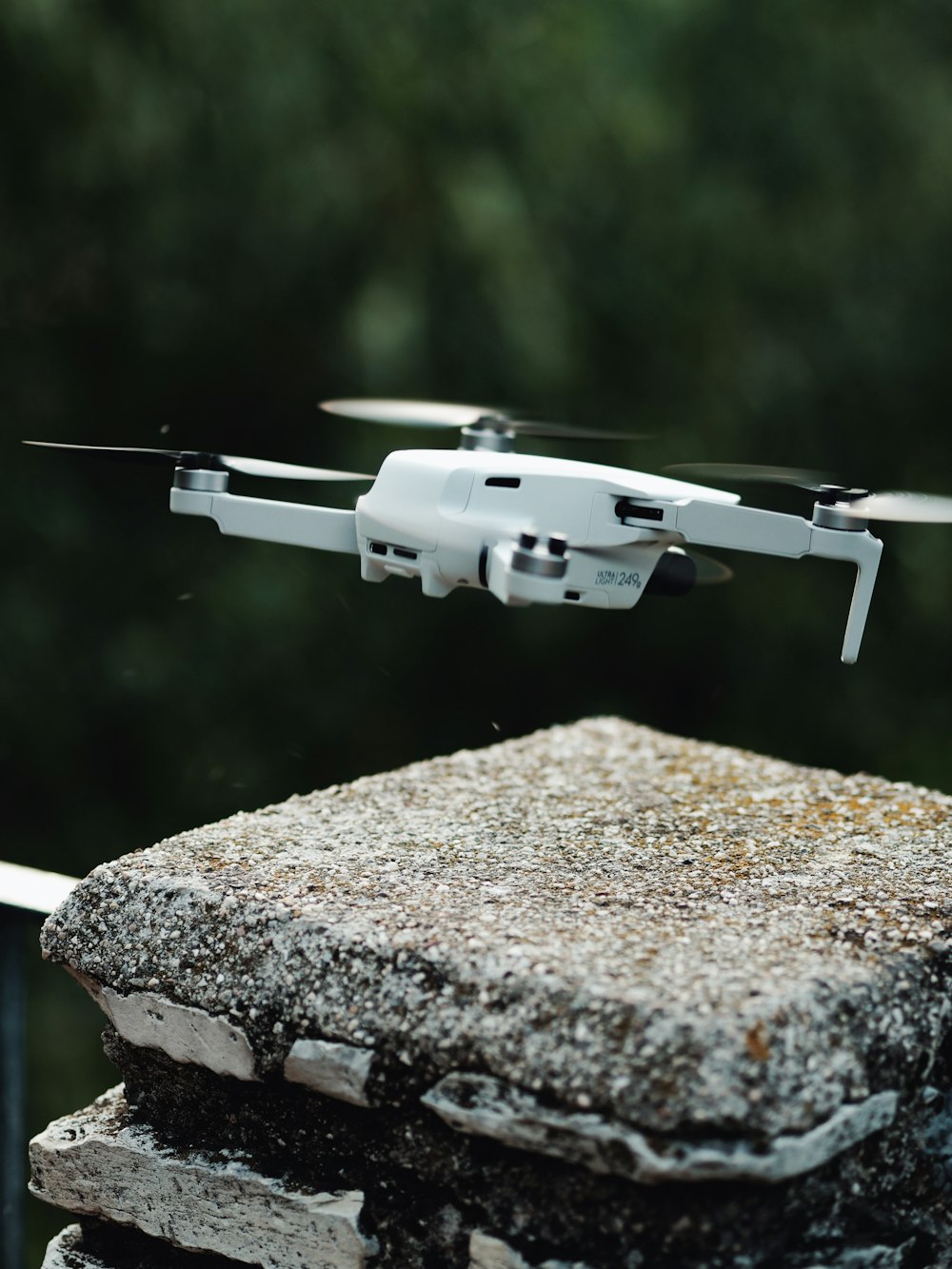 white and black drone on brown concrete surface