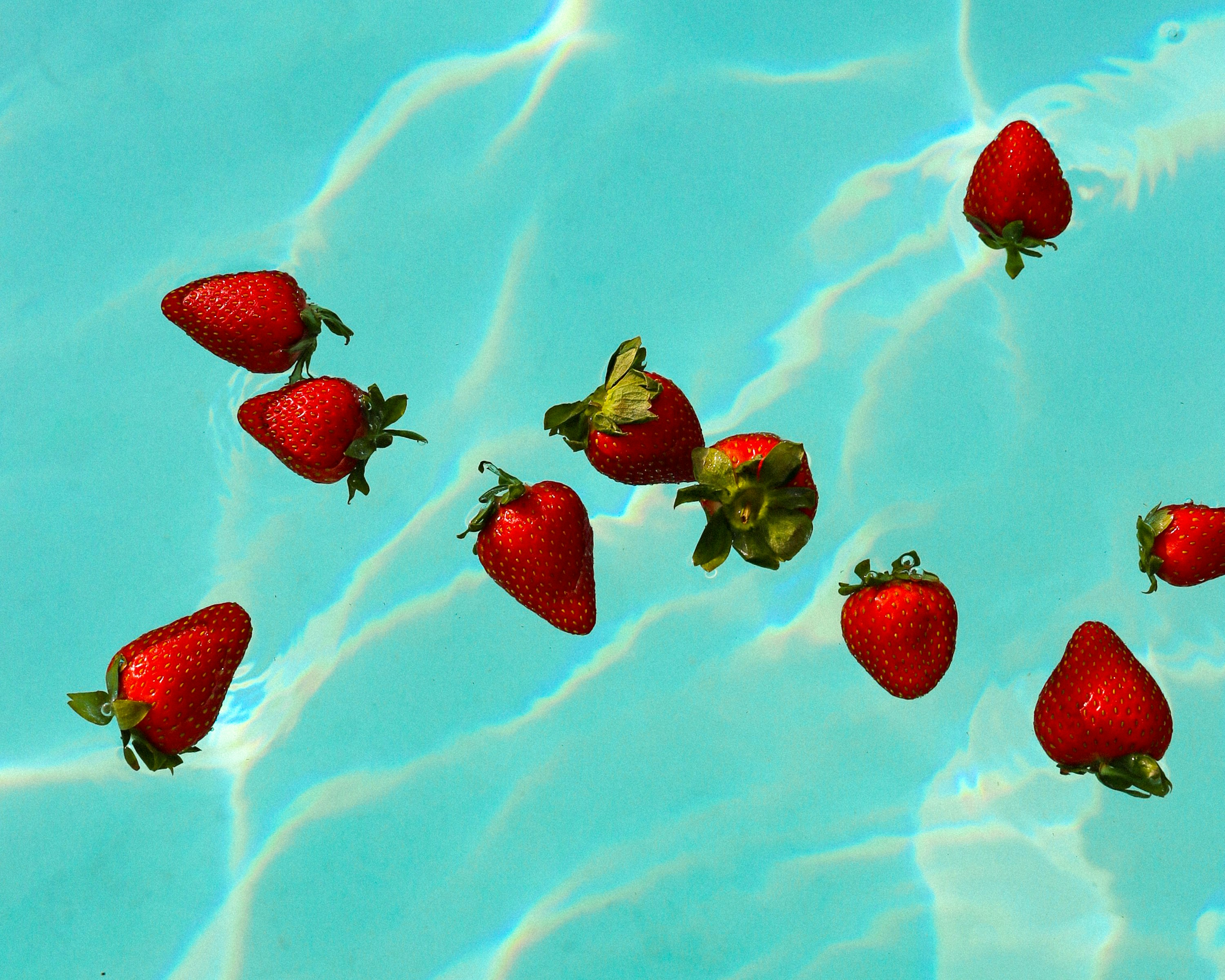 red strawberries on white and blue surface