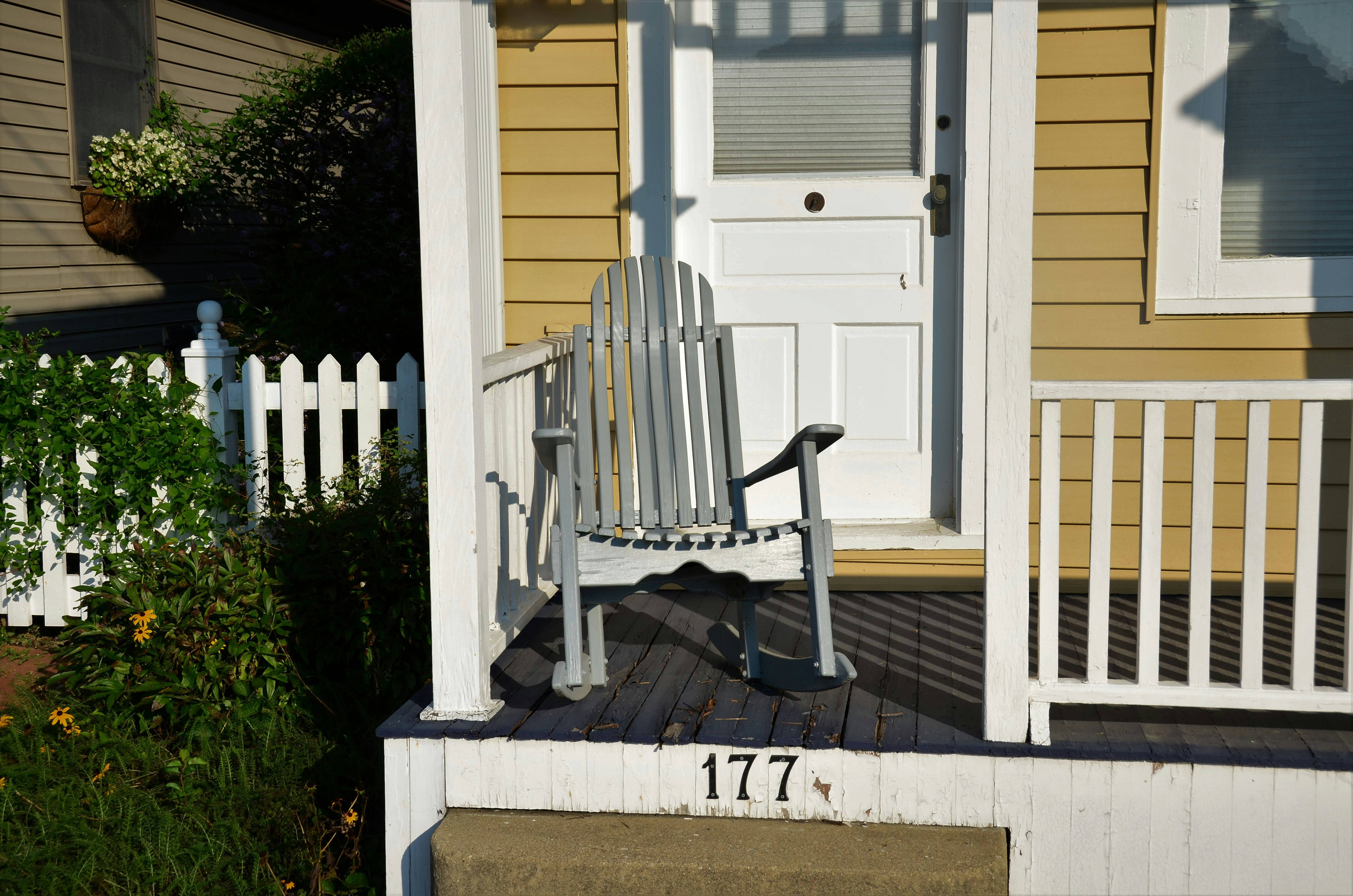 Gray rocker on white porch