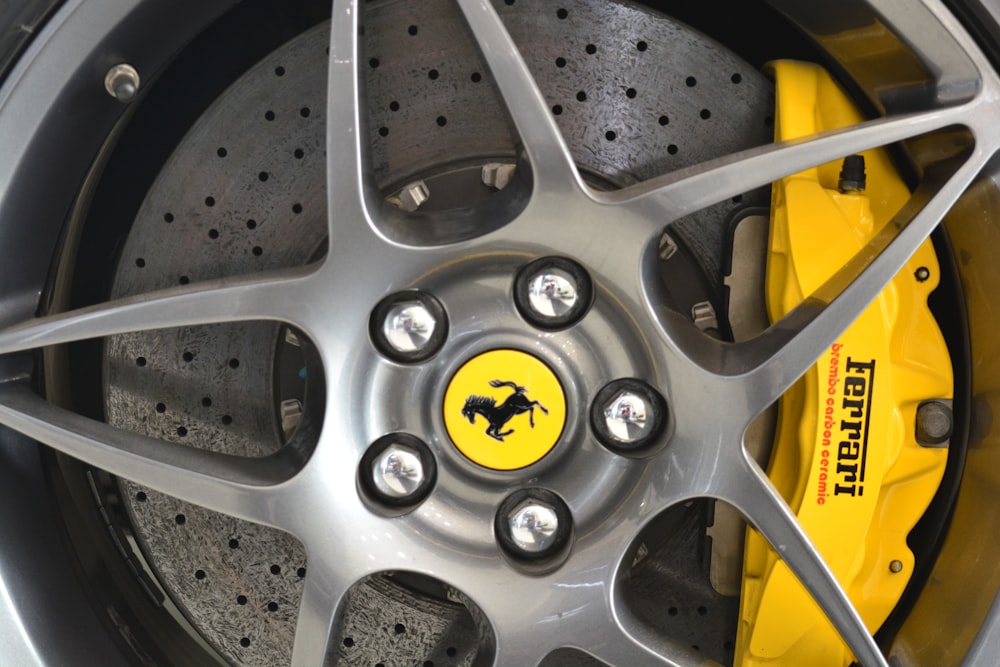 silver and yellow wheel with tire