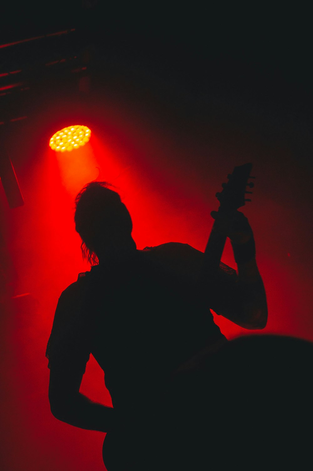 silhouette of man playing guitar