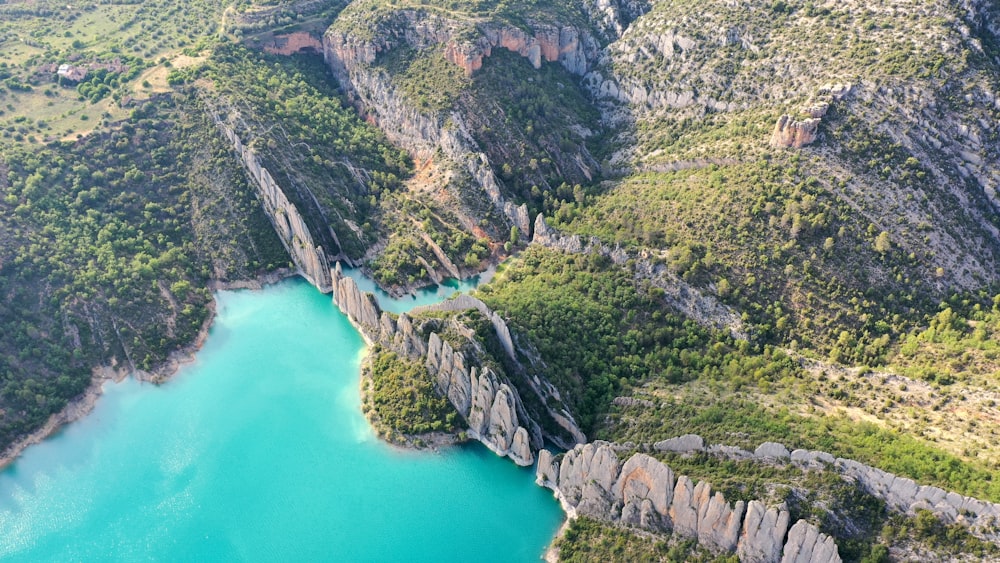 green and brown mountain beside body of water during daytime