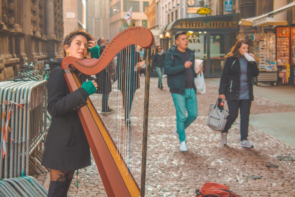 woman in green long sleeve shirt playing musical instrument