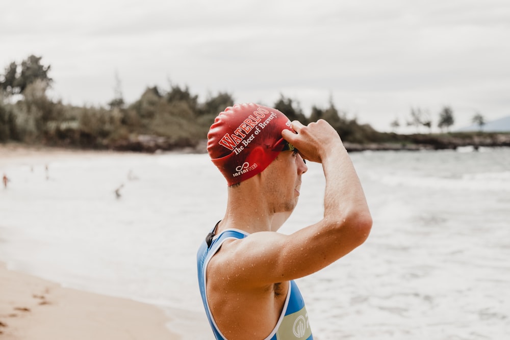 woman in blue tank top wearing red cap