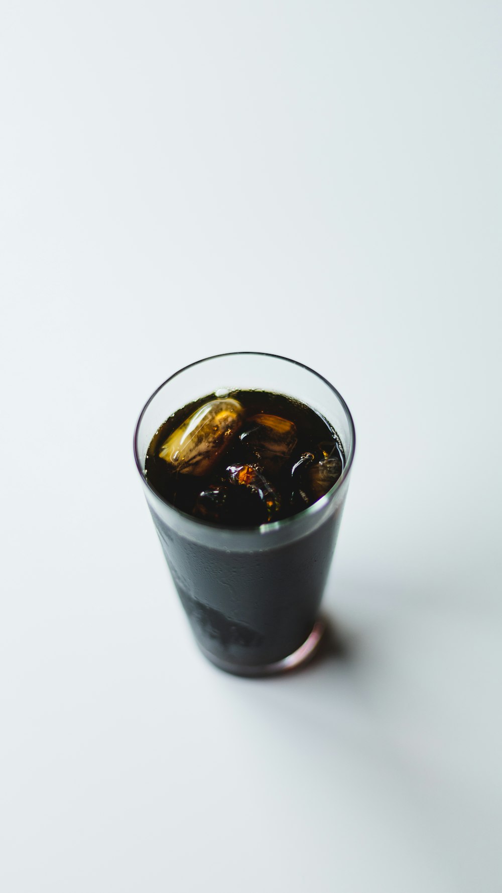 black liquid in clear drinking glass