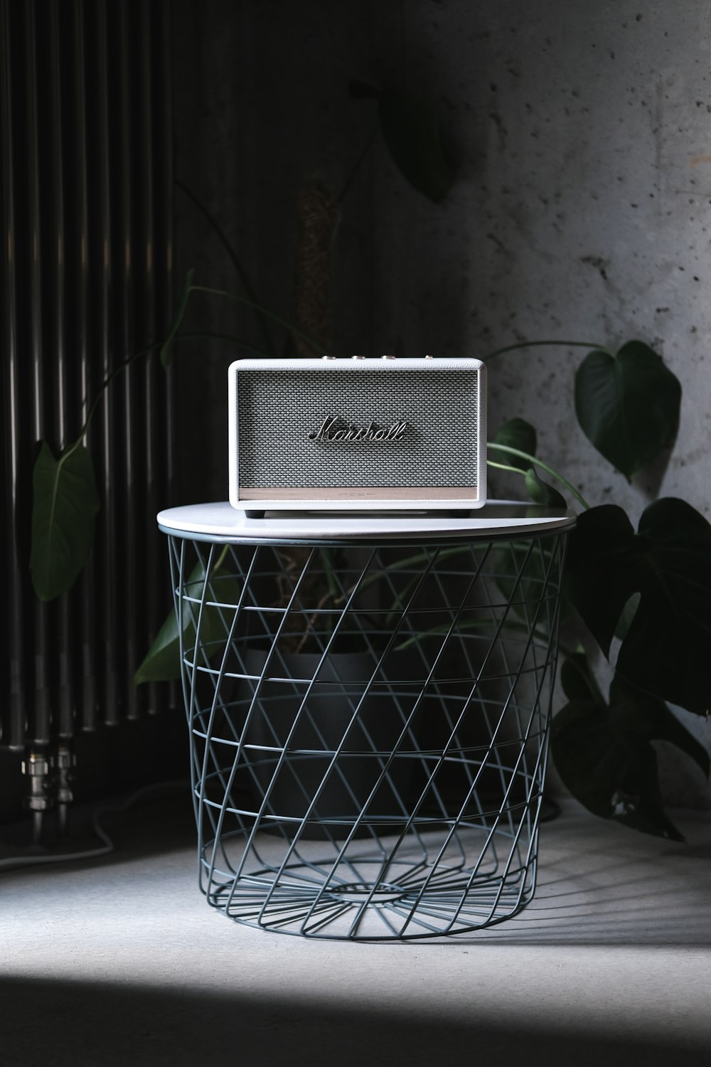 white and gray speaker on white metal table