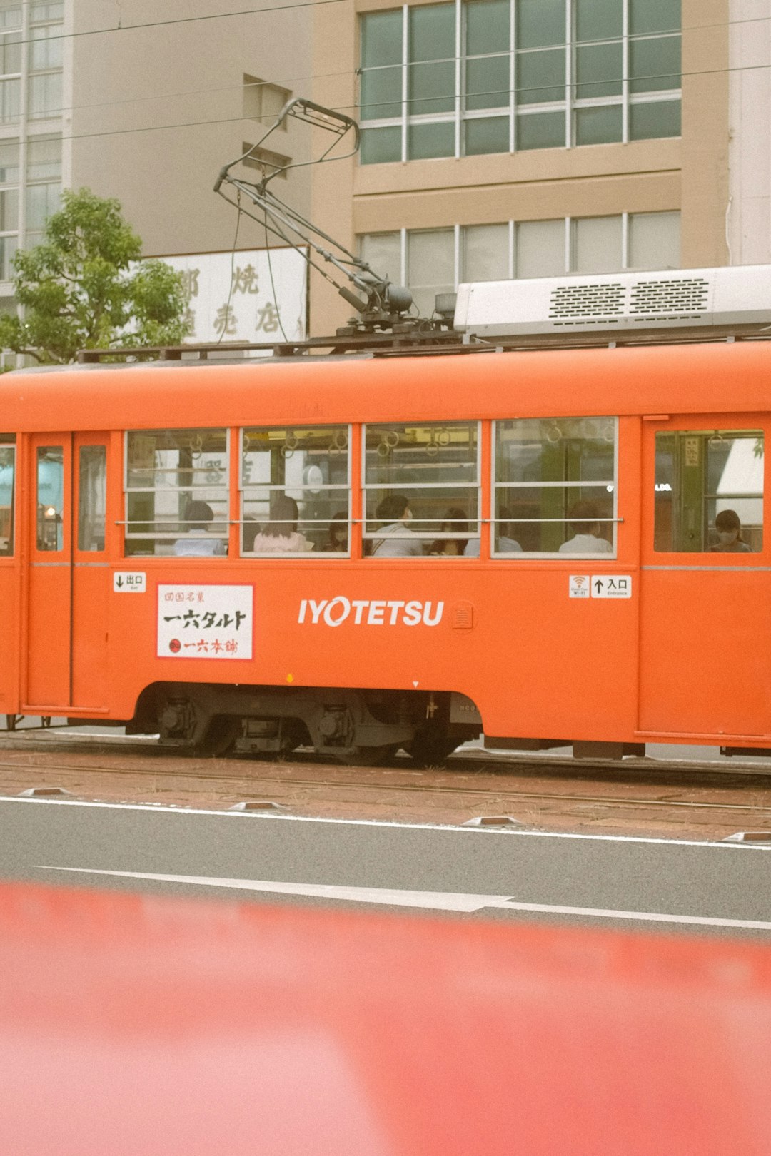 red and black tram on road during daytime