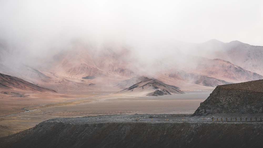 black and white mountain under white clouds during daytime