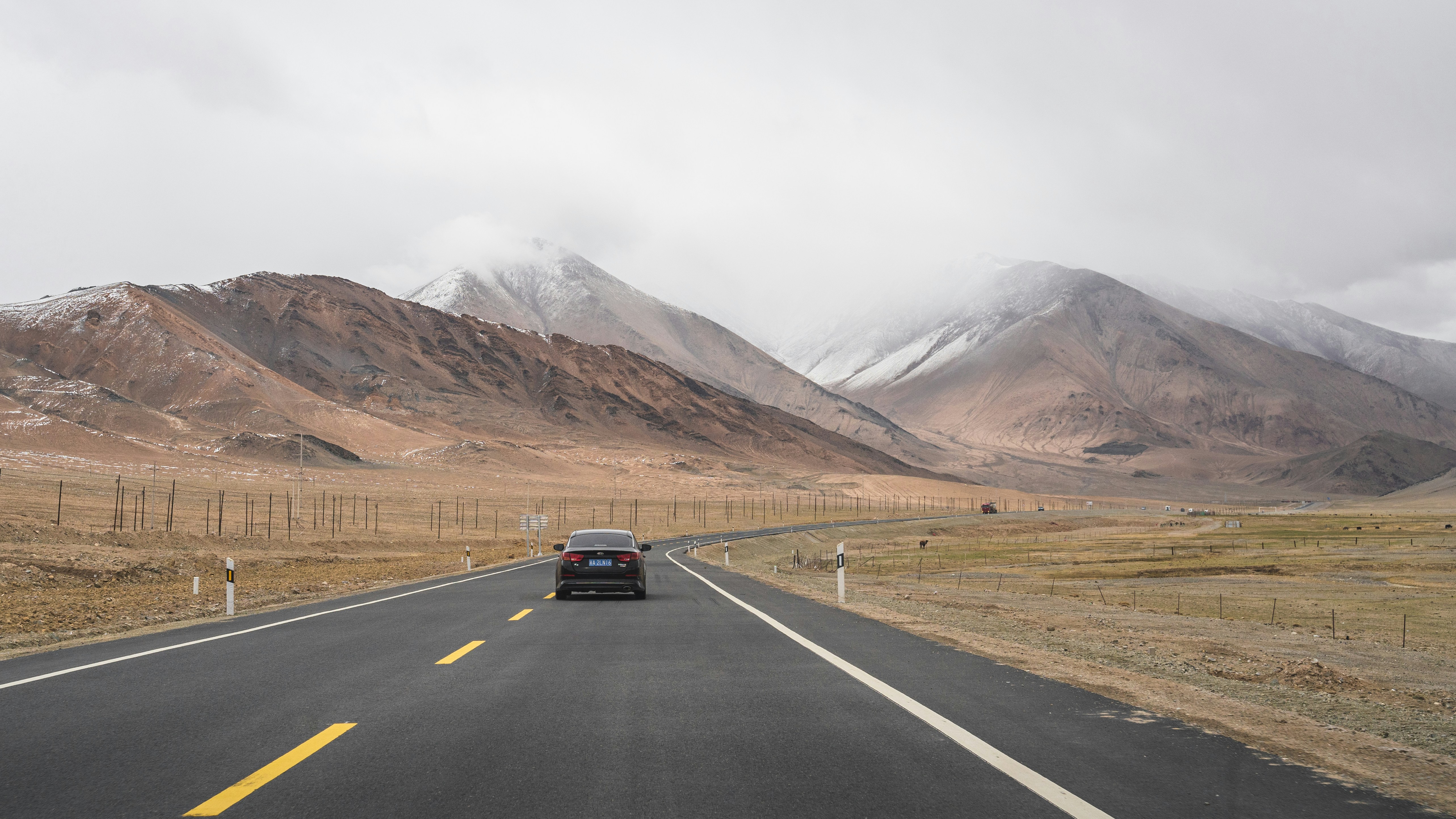black suv on road near brown mountain during daytime