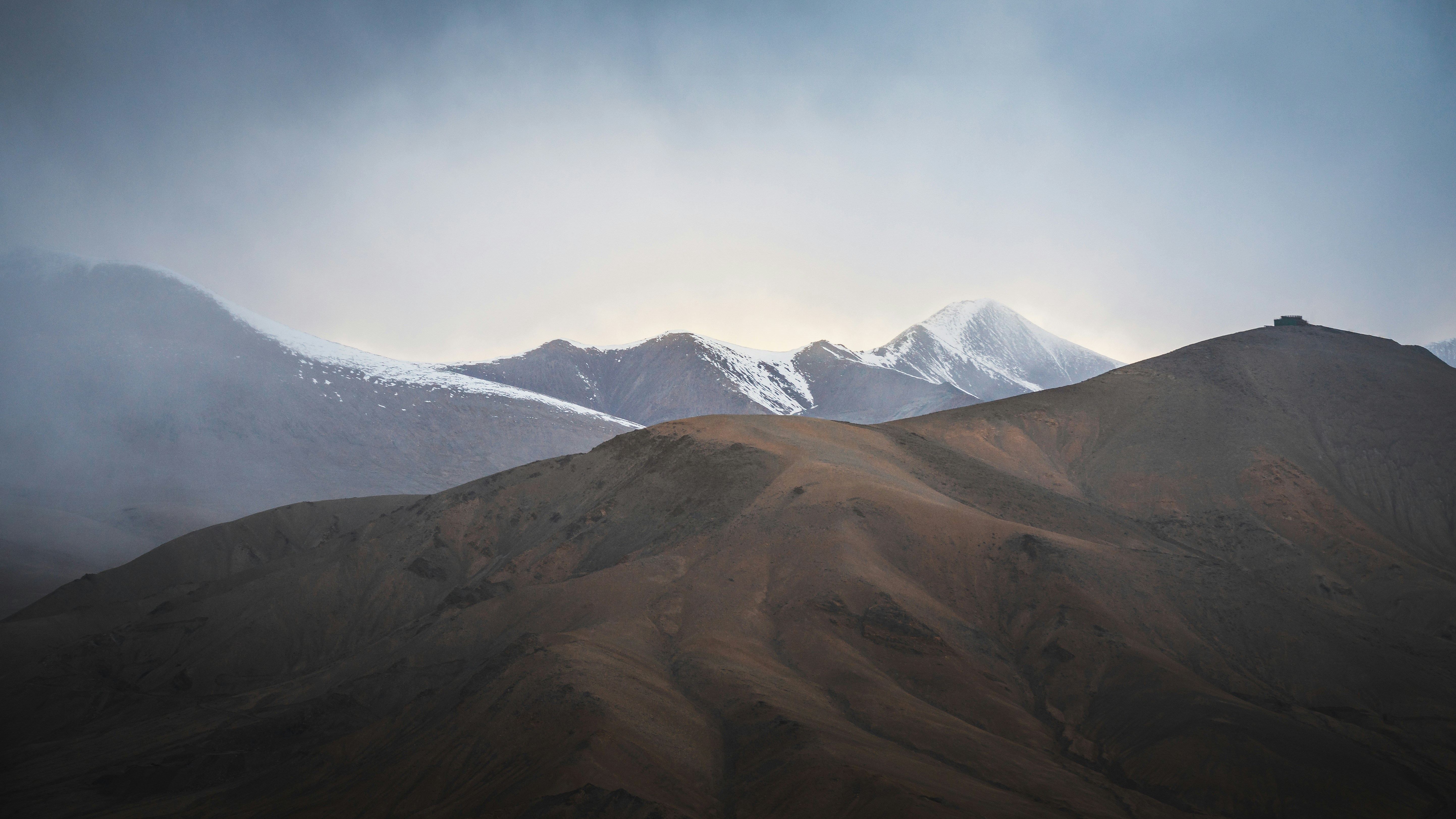 brown and white mountains under blue sky during daytime