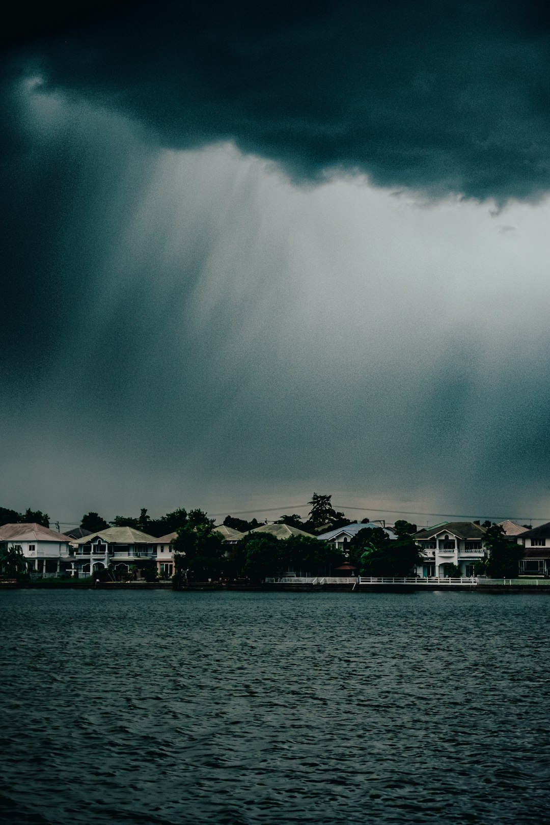 white and brown house near body of water during daytime