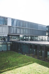 green grass field near building during daytime