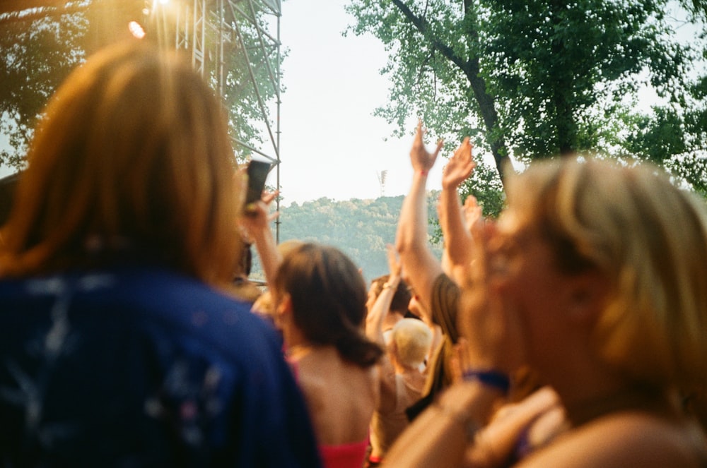 people standing near green trees during daytime