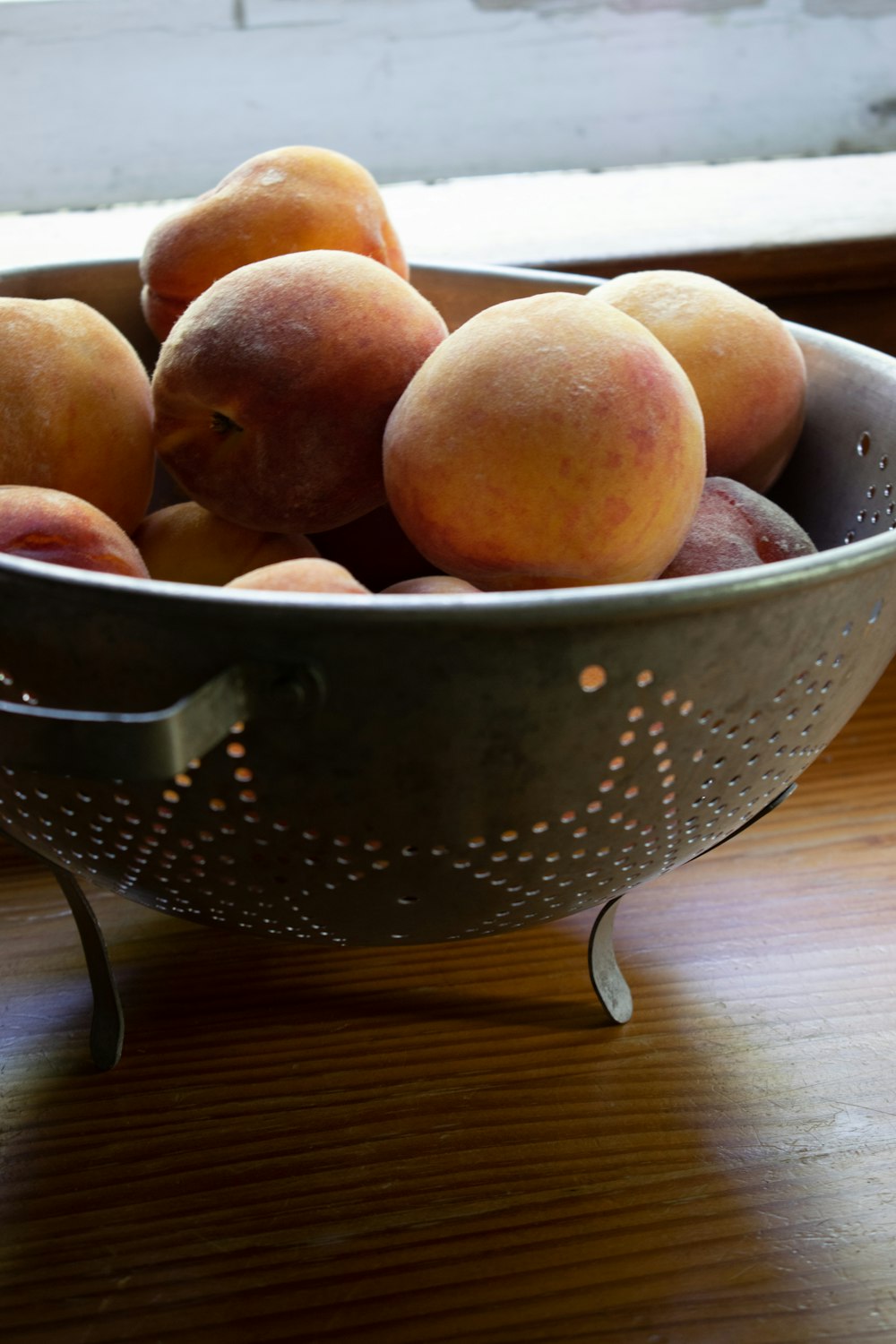 brown round fruits on stainless steel basket