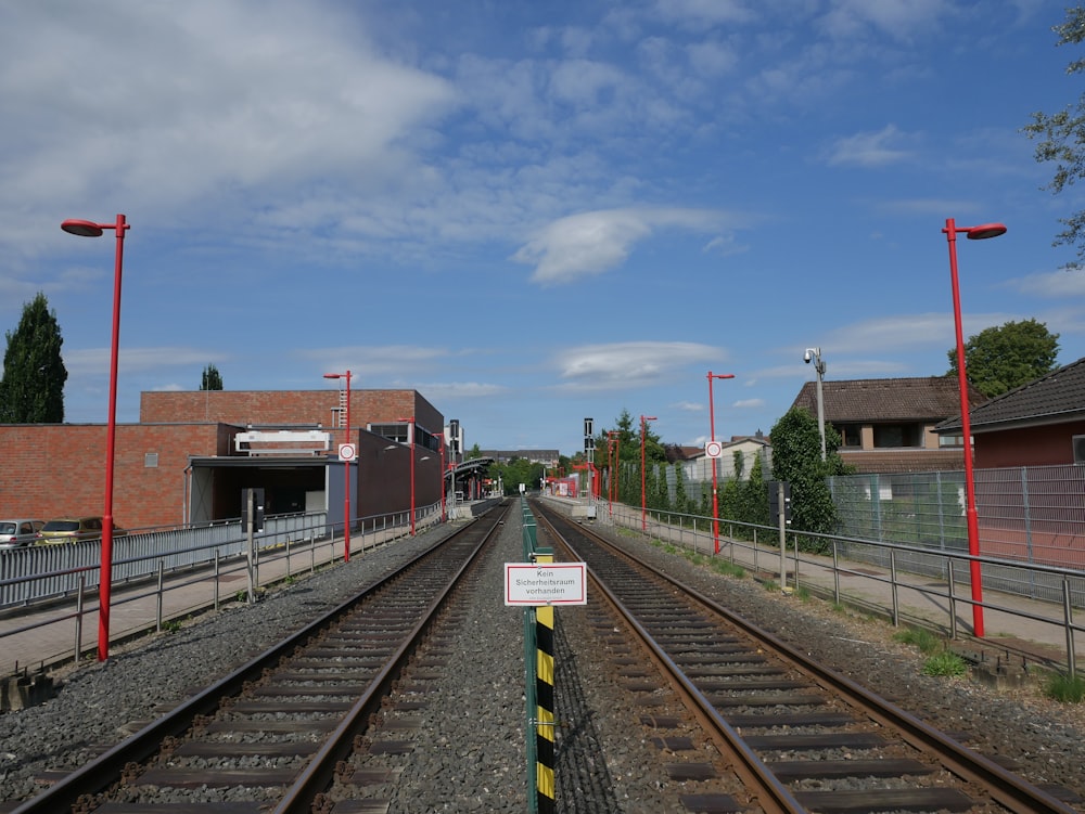 train rail near brown building during daytime