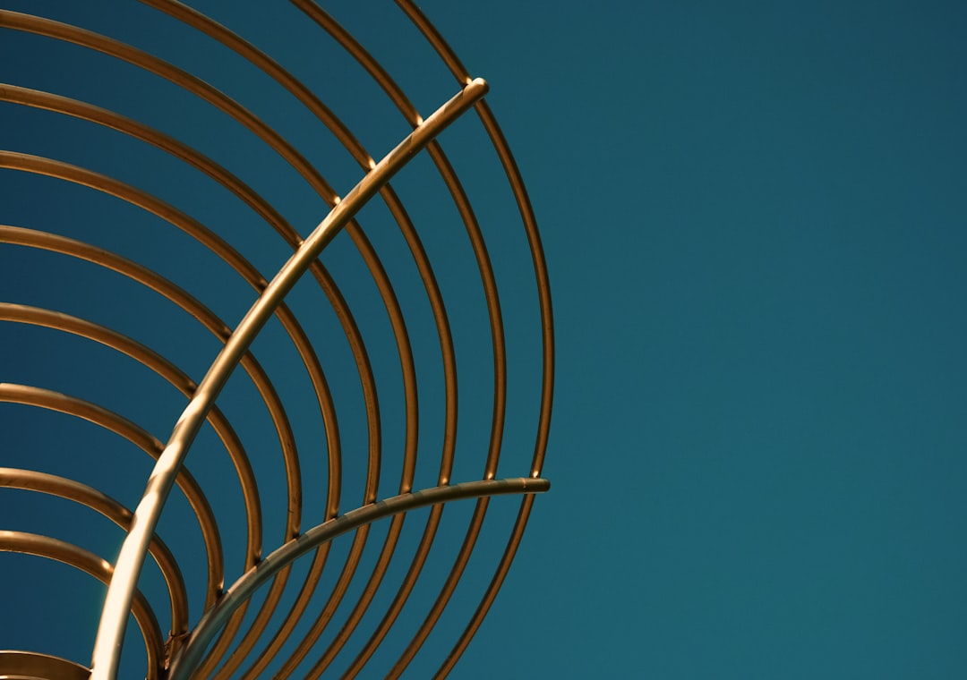 gray metal spiral stairs under blue sky during daytime