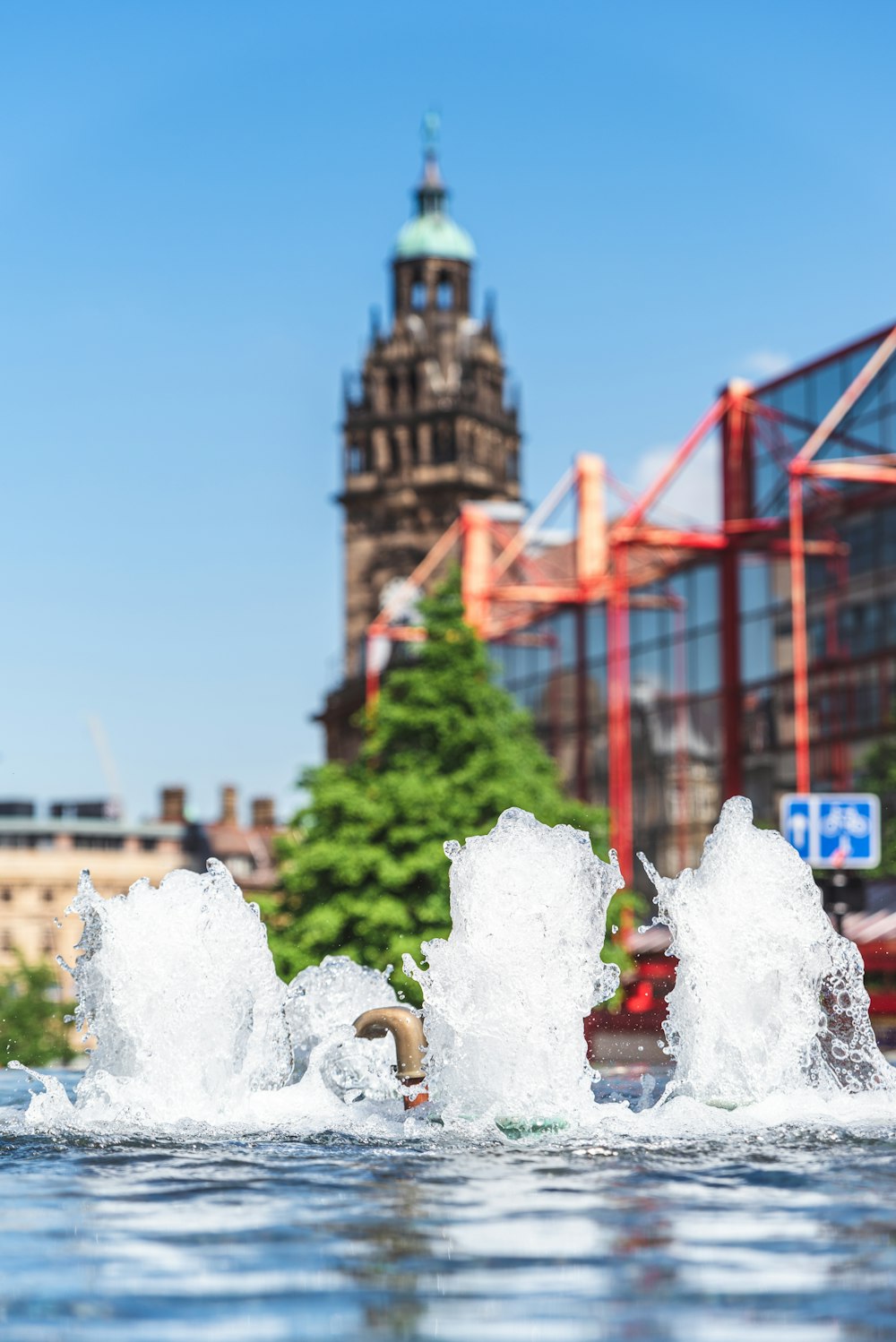 water fountain near red bridge during daytime