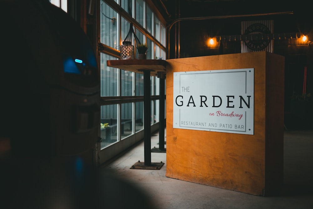 brown wooden signage on brown concrete building