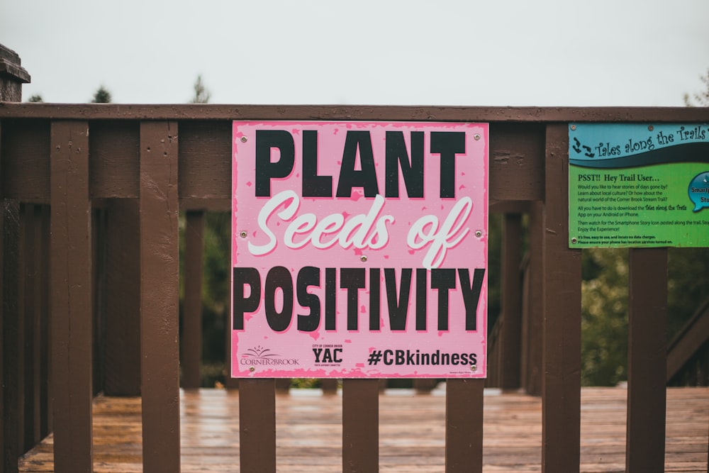 pink and white wooden signage