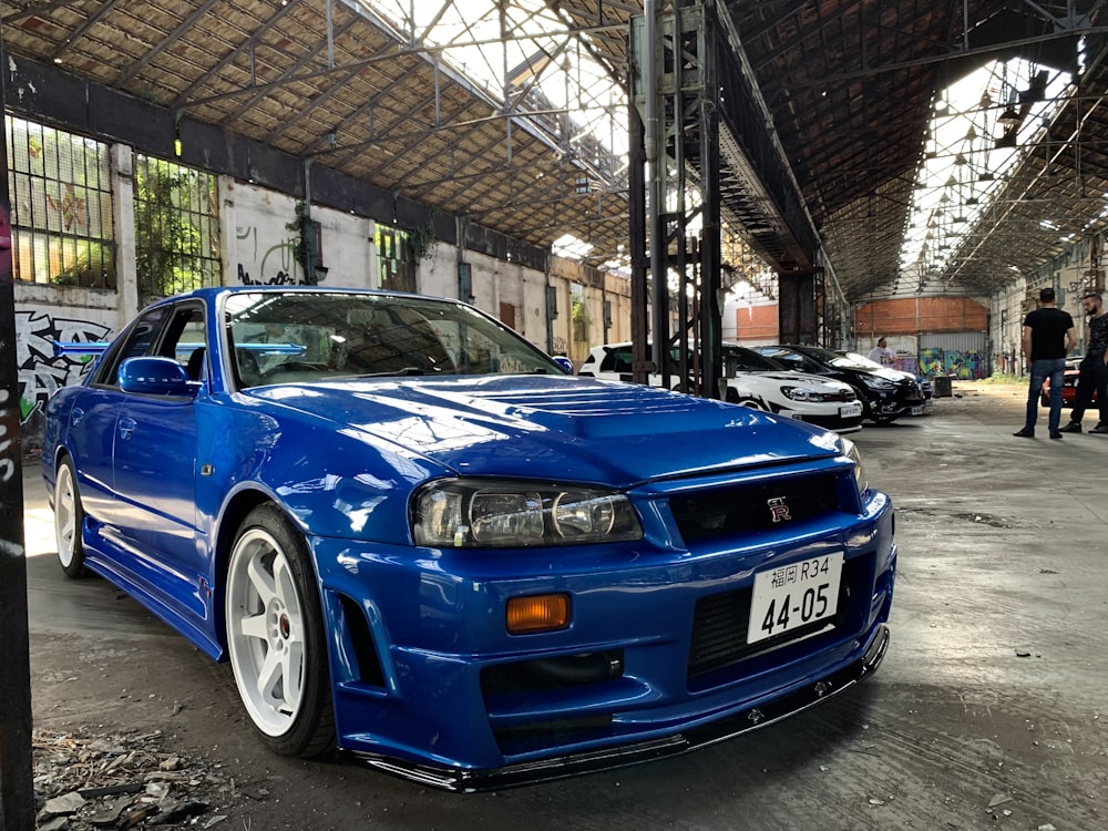 blue bmw m 3 parked on garage