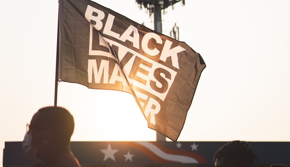 a black lives matter flag flying in the air