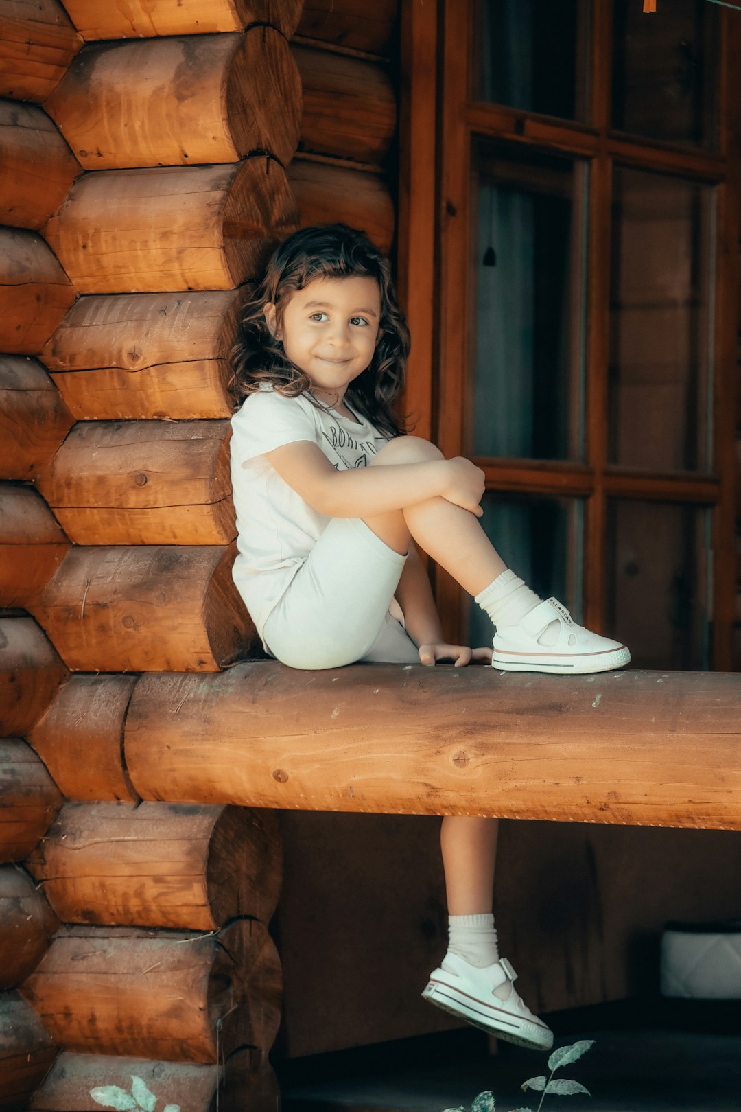 woman in white dress sitting on brown wooden bench