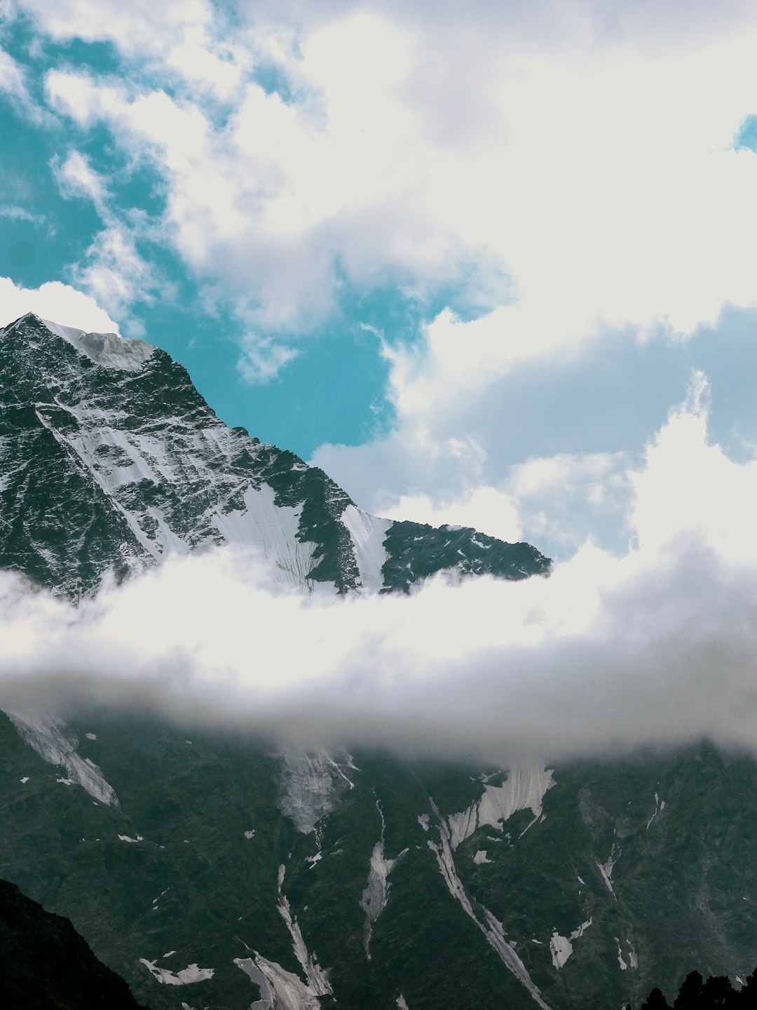 snow covered mountain under cloudy sky during daytime