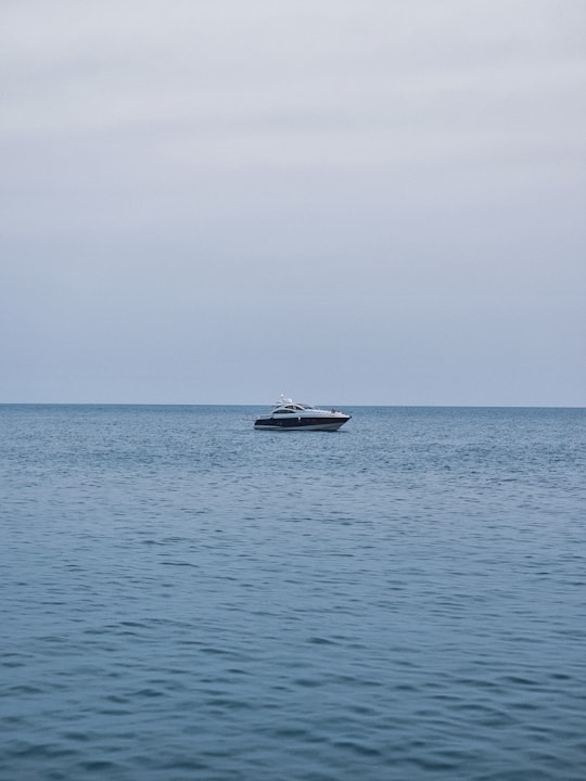 white and black boat on sea during daytime in Ulcinj Montenegro