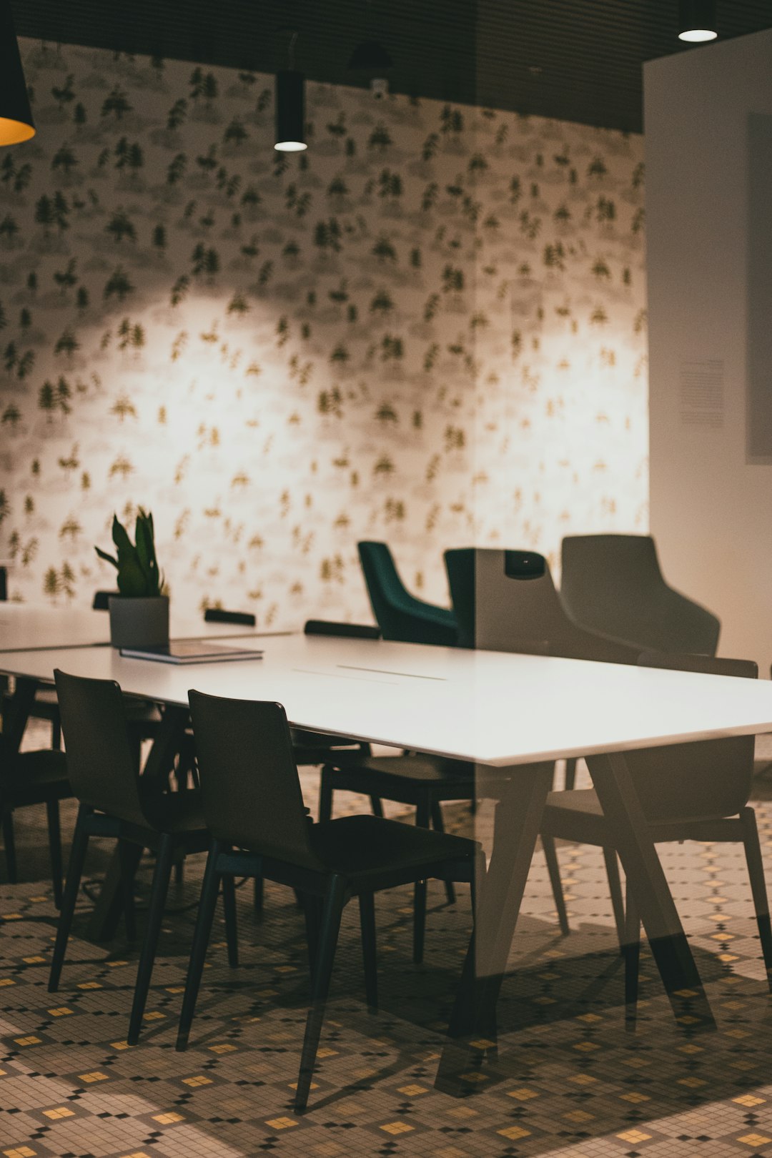 black chairs and table near white wall