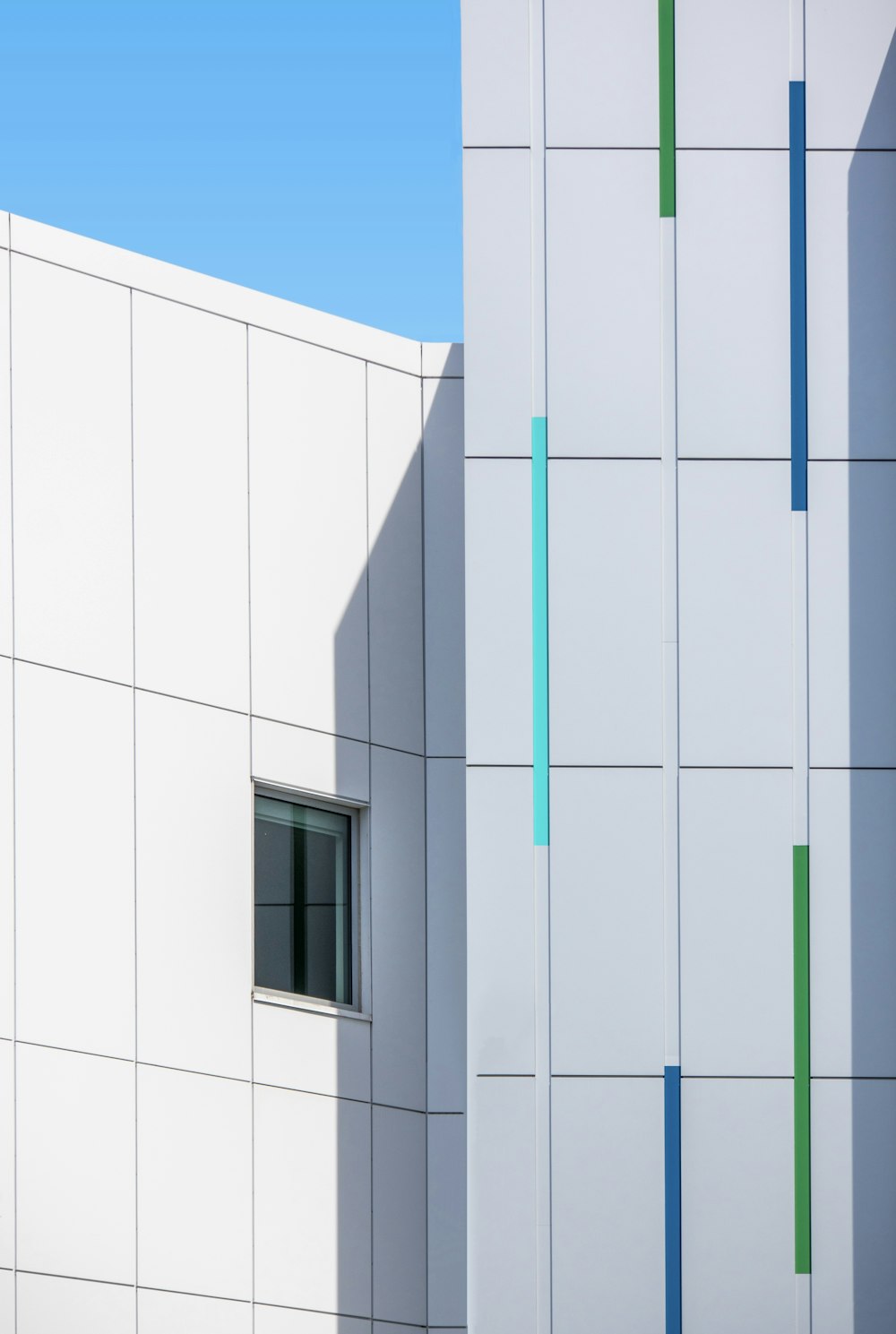 white concrete building with green metal door