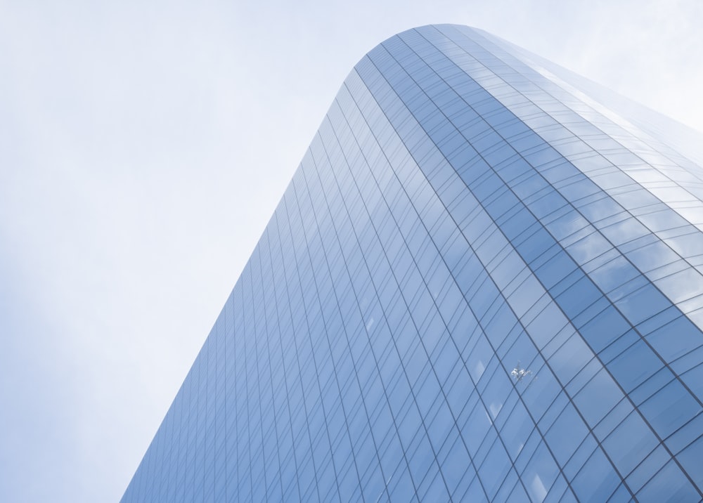 white and blue glass walled high rise building