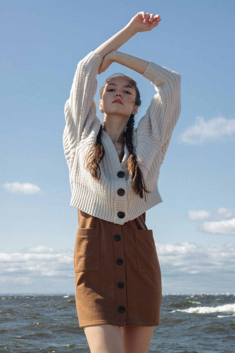 woman in white and brown striped button up shirt and brown pants