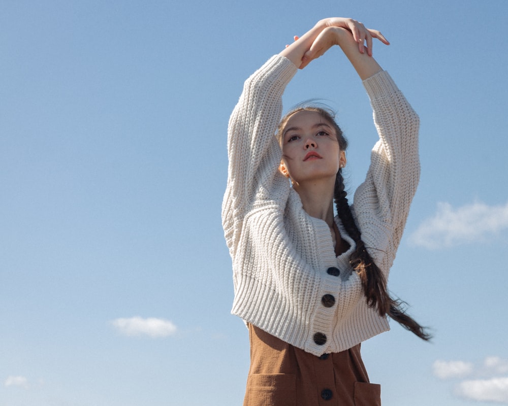 woman in white and black striped long sleeve shirt and brown pants