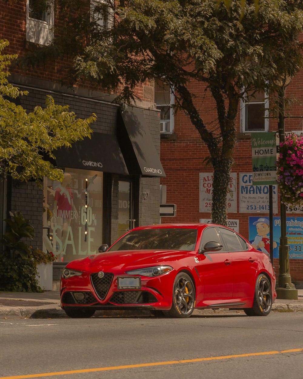 red bmw m 3 parked near brown and white building during daytime