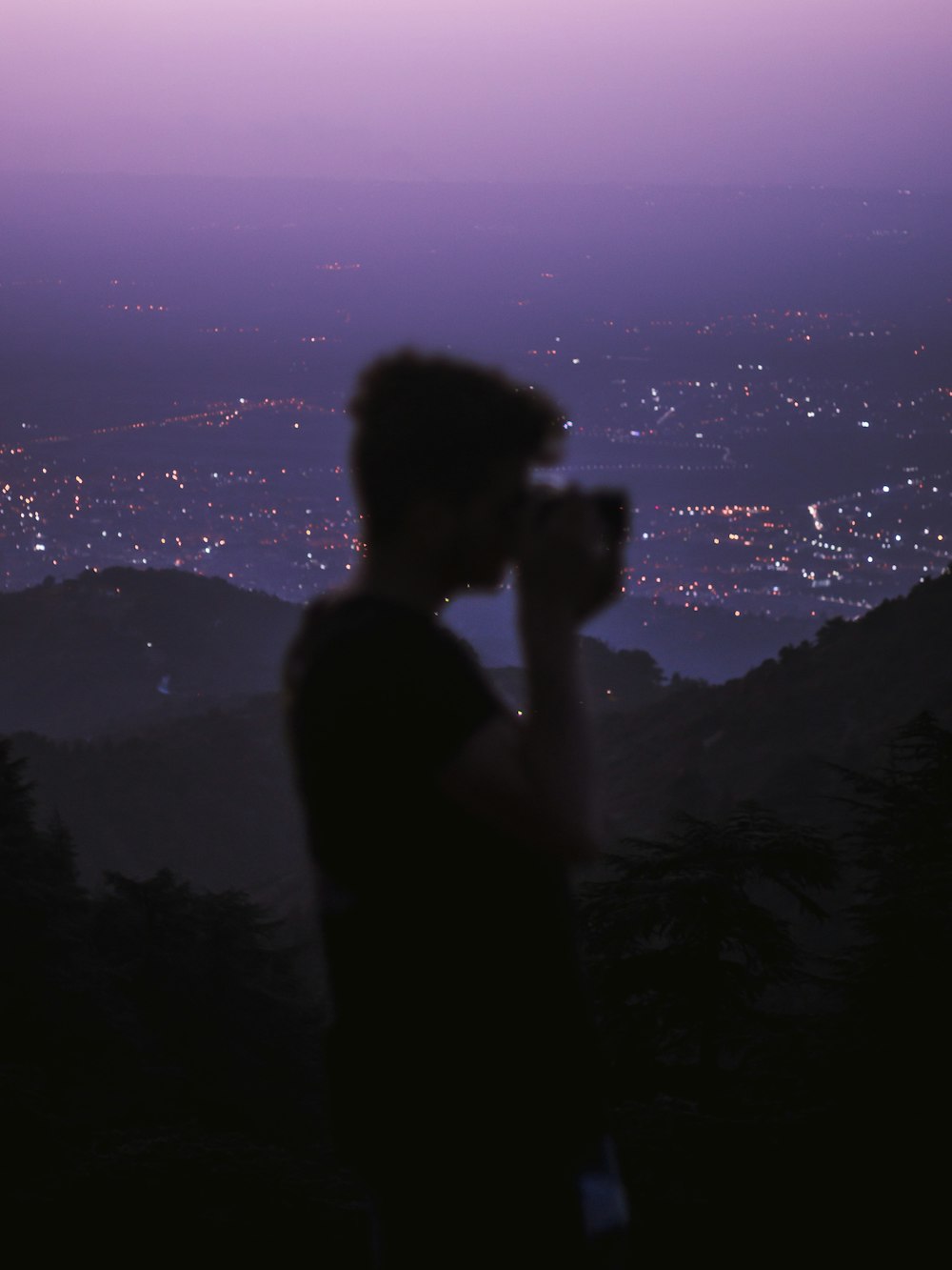 silhouette of woman standing on top of mountain during night time