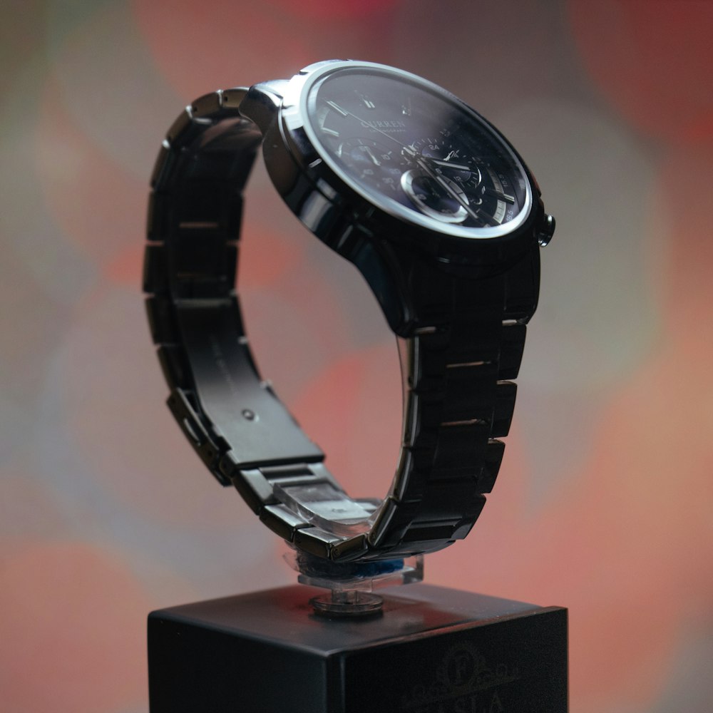 black and silver round watch