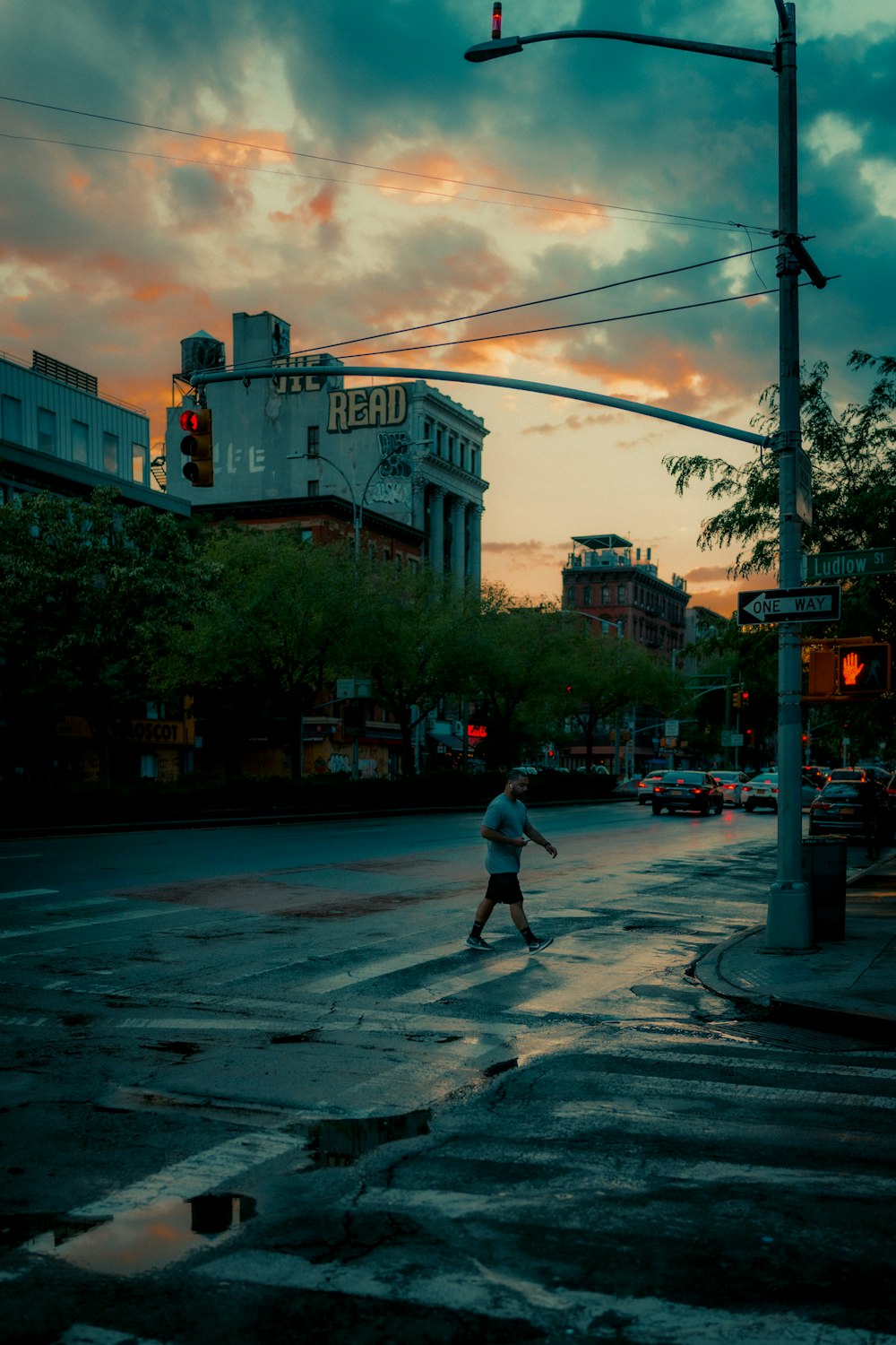 man in white shirt and black pants walking on pedestrian lane during daytime